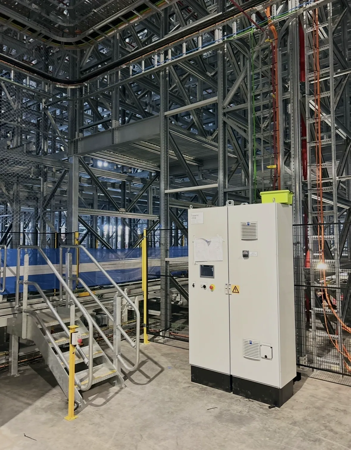 AS/RS control cabinet, conveyor and mini-load racking installed by Hexar Solutions — warehouse automation electrical works